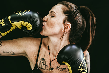 woman kissing black leather boxing gloves thumbnail
