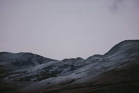 gray and black ground mountain under cloudy sky thumbnail