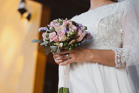 newlywed woman holding boquet thumbnail