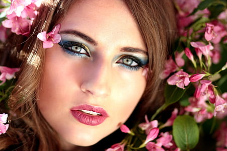 woman wearing eyeshadow surrounded with pink petal flower thumbnail