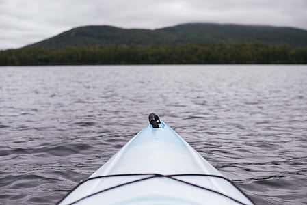 white kayak on body of water thumbnail