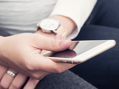 person holding gold iPhone thumbnail