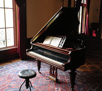 photography of brown wooden grand piano with chair thumbnail
