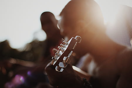 man playing guitar during daytime thumbnail