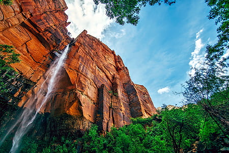 waterfalls between rock mountain during daytime thumbnail