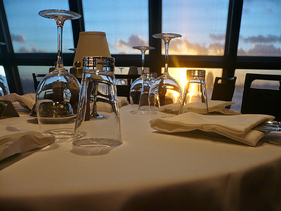 upside down drinking glasses on fine dining setting during golden hour thumbnail
