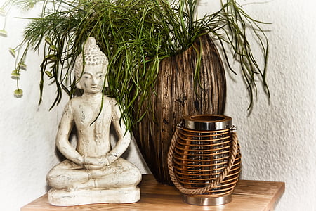 gautama Buddha figurine near brown wooden vase thumbnail