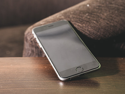 space gray iPhone 6 on brown wooden table thumbnail