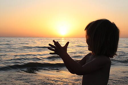 silhouette photo of girl beside body of water thumbnail