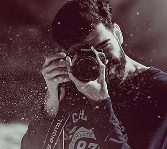 grayscale photo of man taking photo thumbnail