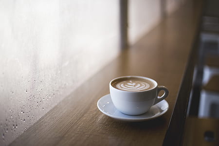 cappuccino cup on table beside glass window thumbnail