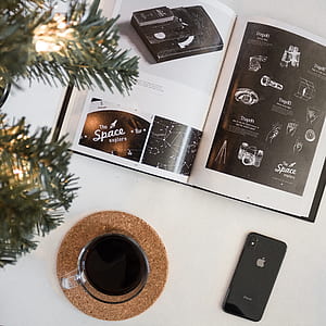 space gray iPhone X beside clear glass mug thumbnail