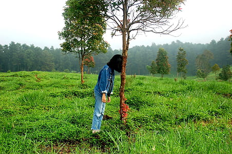 person leaning on tree thumbnail
