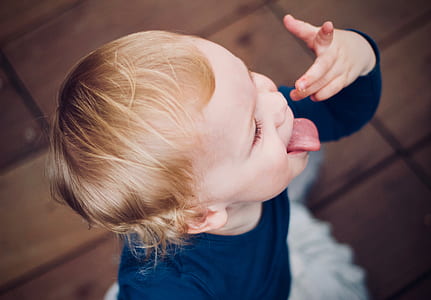 boy standing on white textile thumbnail