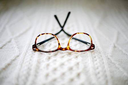 brown framed eyeglasses placed cushion thumbnail