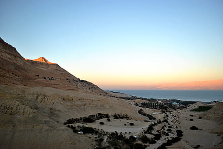 aerial photography of brown mountain under blue and orange sky thumbnail