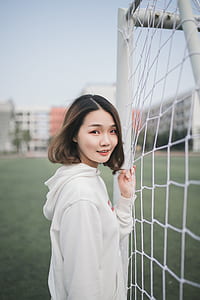 woman beside goalie net thumbnail