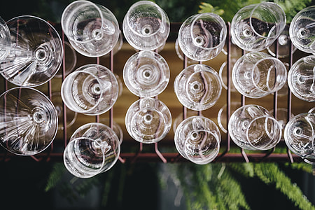 A big bunch of wine glasses hanging from a holder thumbnail