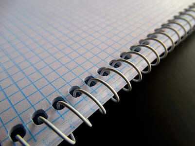 blue graphing notebook on black surface thumbnail