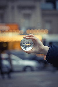Person Holding Round Glass Ball Macro Shot thumbnail