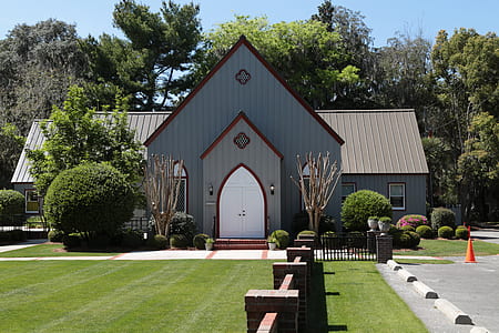 gray and white church near trees thumbnail
