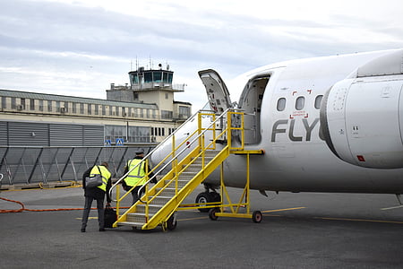 person standing under airplane thumbnail