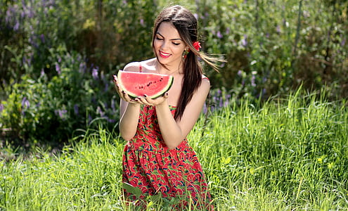 woman in red floral dress holding watermelon fruit thumbnail