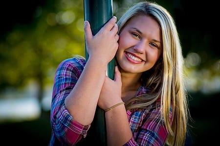 Photo of Woman Holding Green Post While Smiling thumbnail