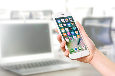 person holding turned on silver iPhone 6 thumbnail