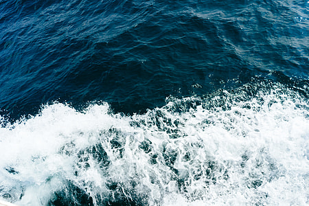 body of water with splash during daytime thumbnail