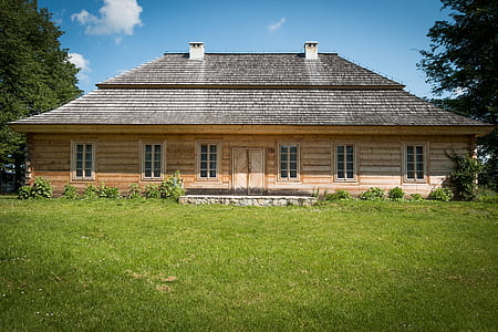 brown wooden house beside trees thumbnail