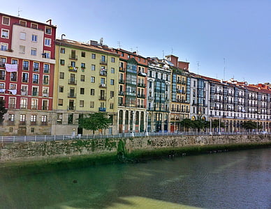 multicolored concrete building lot near river thumbnail