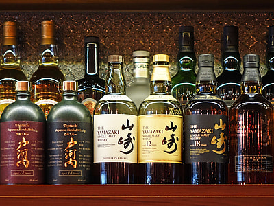 low light photography of liquor bottles thumbnail