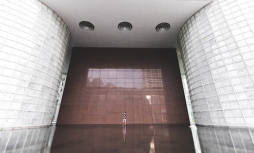 photography of person standing inside building during daytime thumbnail