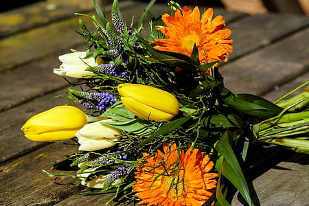 yellow and orange petaled flower bouquet on brown wooden surface thumbnail