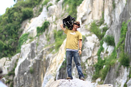 selective focus photography of man standing on rock thumbnail