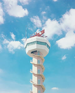 photo of a white concrete tower during day time thumbnail