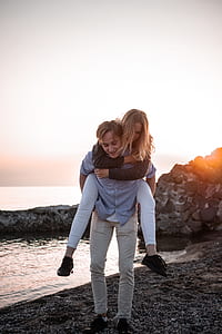 woman horseback riding man on seashore thumbnail