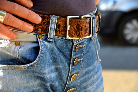 closeup photo of person wearing blue denim bottoms with brown belt thumbnail