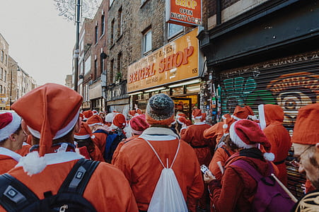 people wearing Santa Claus costume walking on road thumbnail