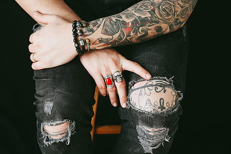 person sitting on chair in distressed pants thumbnail