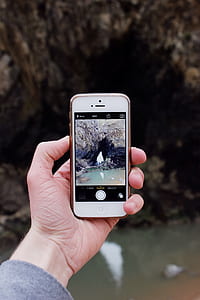 person taking photo of rock formation thumbnail