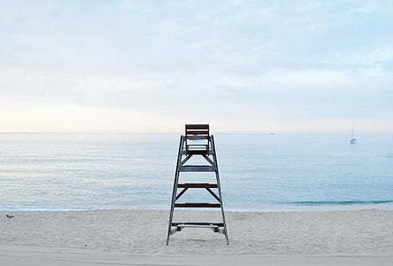 black metal lifeguard chair on white sand near sea thumbnail