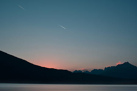 mountains near body of water thumbnail