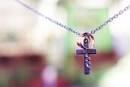 gray cross and two gold-colored rings pendant thumbnail