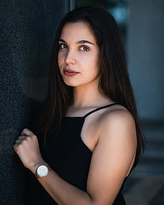 woman wearing spaghetti strap top leaning on wall thumbnail