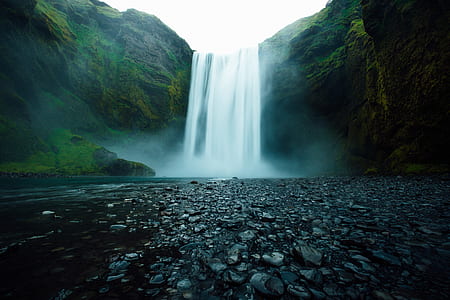 timelapse photograph of waterfalls rushing on to river thumbnail