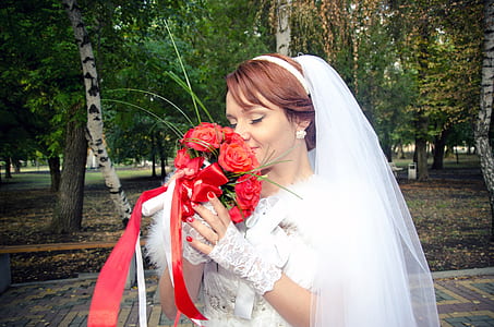 bridge smelling red rose bouquet during daytime thumbnail