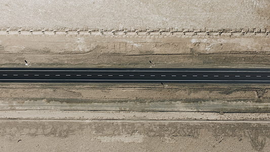 aerial photograph of pavement road between brown soil thumbnail