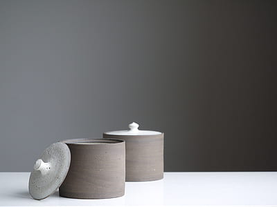 two gray canister on the white wood thumbnail